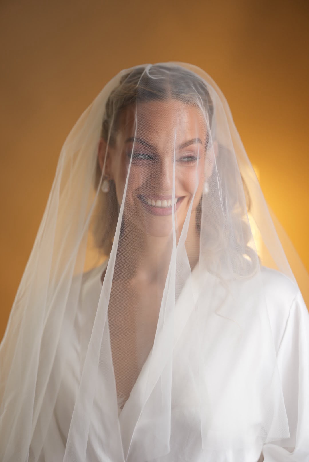 Bride smiling beneath her veil